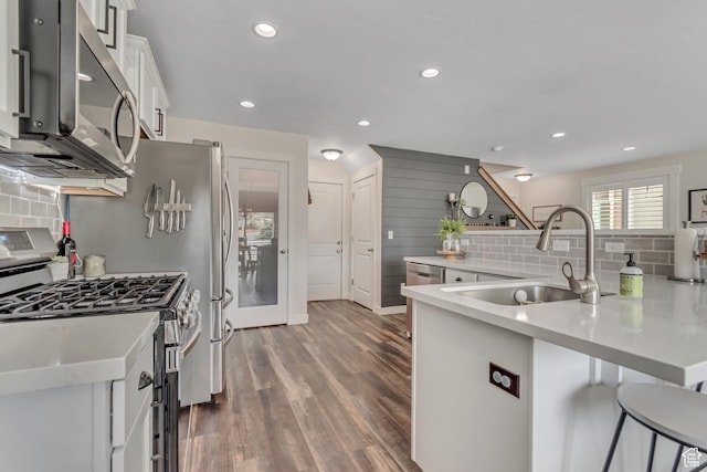 14496 S Edgemere Dr W, Herriman, UT 84096 - kitchen featuring stainless steel appliances, a sink, decorative backsplash, white cabinets, and recessed lighting