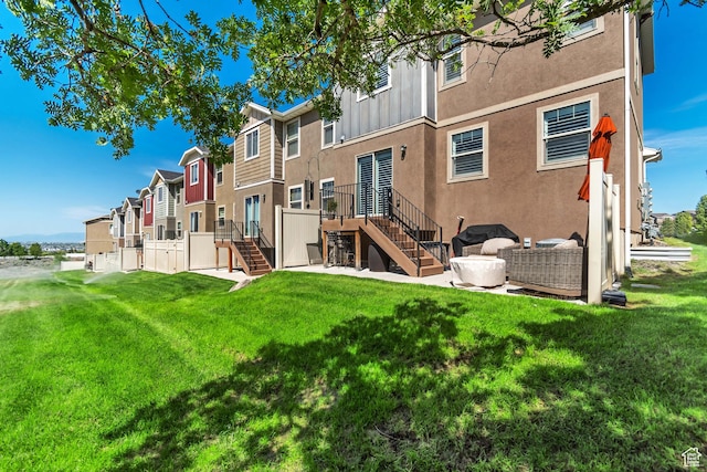 14496 S Edgemere Dr W, Herriman, UT 84096 - rear view of property featuring stairs, stucco siding, a residential view, and a yard