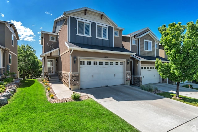 14496 S Edgemere Dr W, Herriman, UT 84096 - craftsman-style house featuring stone siding, a garage, board and batten siding, concrete driveway, and a front lawn