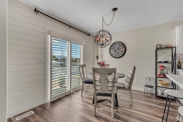 14496 S Edgemere Dr W, Herriman, UT 84096 - dining room with a chandelier, wood finished floors, wooden walls, and baseboards