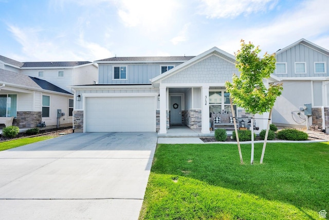 3154 S Edgewater Ln W, Syracuse, UT 84075 - craftsman-style house featuring board and batten siding, a porch, concrete driveway, stone siding, and a front yard