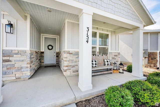 3154 S Edgewater Ln W, Syracuse, UT 84075 - doorway to property featuring a porch and stone siding