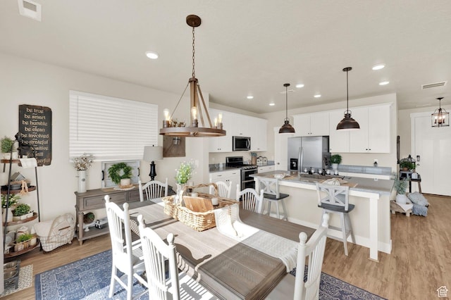 3154 S Edgewater Ln W, Syracuse, UT 84075 - dining area featuring light wood finished floors and recessed lighting