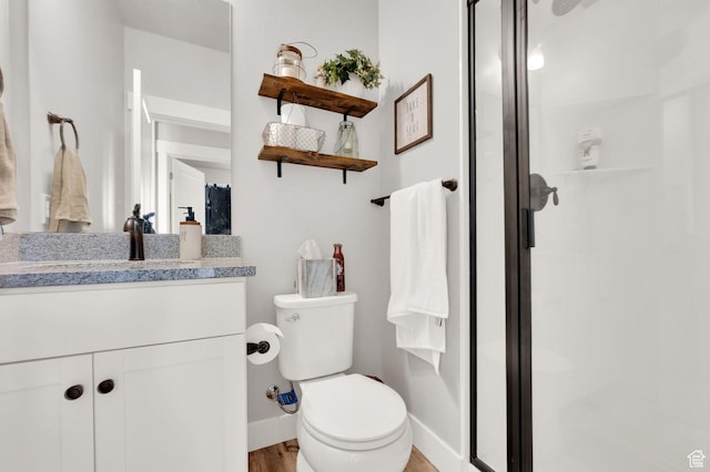 3154 S Edgewater Ln W, Syracuse, UT 84075 - full bath with toilet, a stall shower, vanity, wood finished floors, and baseboards