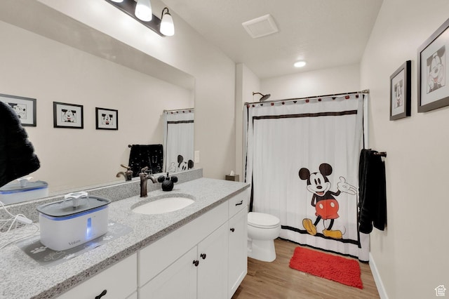 3154 S Edgewater Ln W, Syracuse, UT 84075 - full bath with wood finished floors, vanity, toilet, and a shower with shower curtain