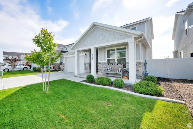 3154 S Edgewater Ln W, Syracuse, UT 84075 - craftsman-style house featuring driveway, covered porch, an attached garage, and stone siding