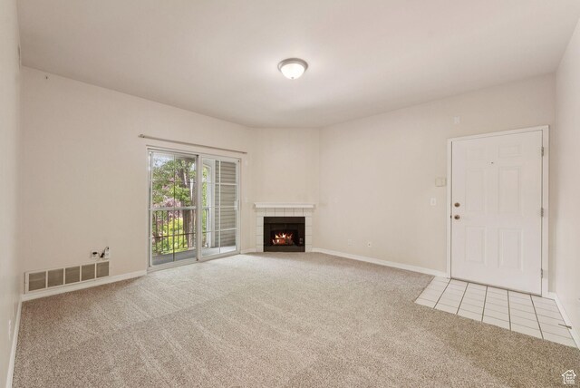 150 S 800 E Unit A9, Salt Lake City, UT 84102 - unfurnished living room featuring carpet floors, baseboards, a fireplace, and tile patterned flooring