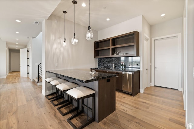 7175 Lupine Dr, Park City, UT 84098 - kitchen featuring dark brown cabinetry, a kitchen breakfast bar, open shelves, light wood-type flooring, and recessed lighting