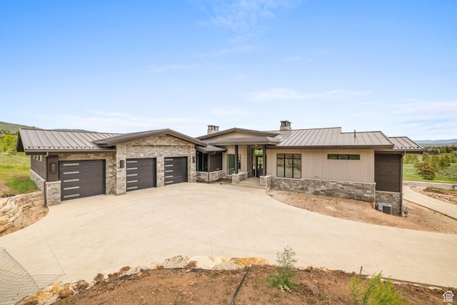 7175 Lupine Dr, Park City, UT 84098 - view of front of home featuring a standing seam roof, stone siding, an attached garage, and metal roof