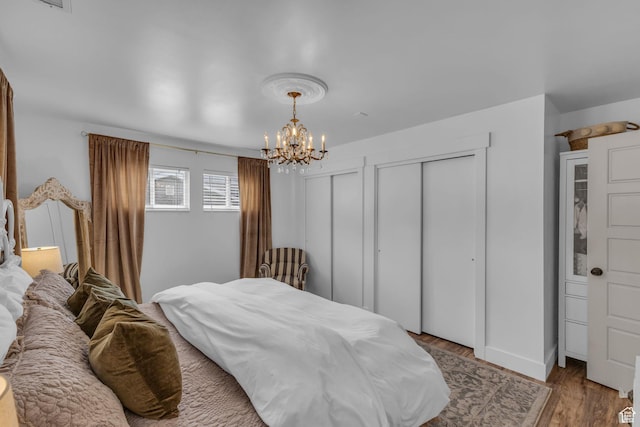 2224 N 600 W, Pleasant Grove, UT 84062 - bedroom with multiple closets, a chandelier, and wood finished floors