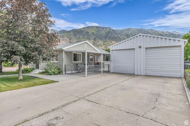2224 N 600 W, Pleasant Grove, UT 84062 - view of front facade with a mountain view, a detached garage, and an outbuilding