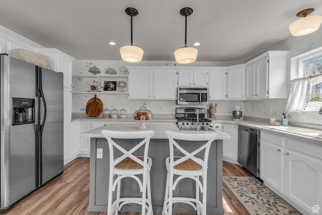 2224 N 600 W, Pleasant Grove, UT 84062 - kitchen with stainless steel appliances, white cabinetry, light countertops, a center island, and light wood-type flooring
