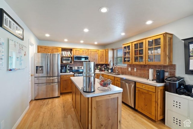 787 N 500 W, Brigham City, UT 84302 - kitchen featuring stainless steel appliances, a sink, tasteful backsplash, a center island, and light wood-style flooring