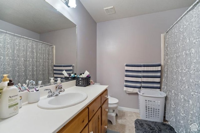 787 N 500 W, Brigham City, UT 84302 - bathroom featuring vanity, toilet, tile patterned flooring, baseboards, and a shower with shower curtain