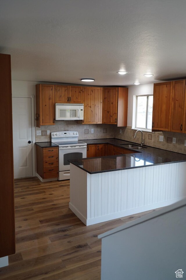 1102 E 120 S, Spanish Fork, UT 84660 - kitchen with white appliances, a sink, dark wood-style floors, dark countertops, and backsplash