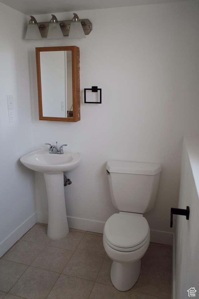 1102 E 120 S, Spanish Fork, UT 84660 - bathroom featuring baseboards, toilet, and tile patterned flooring