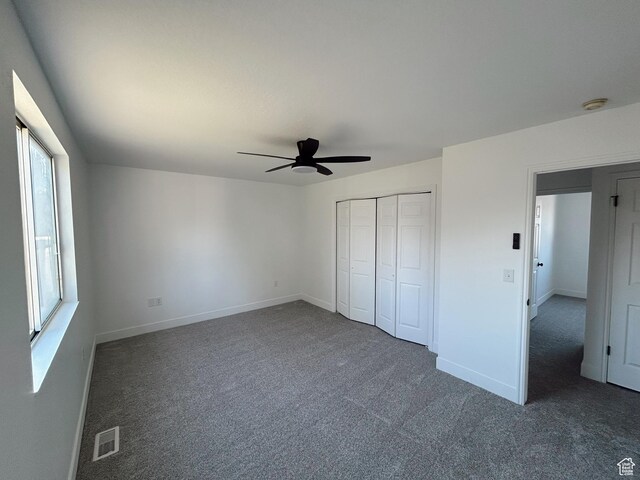 1102 E 120 S, Spanish Fork, UT 84660 - unfurnished bedroom featuring dark colored carpet, multiple windows, baseboards, and ceiling fan