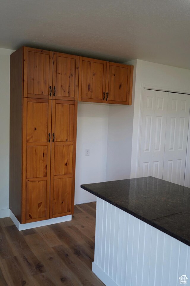 1102 E 120 S, Spanish Fork, UT 84660 - kitchen featuring dark wood-style flooring, brown cabinetry, and dark countertops