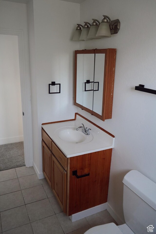 1102 E 120 S, Spanish Fork, UT 84660 - half bath featuring toilet, vanity, baseboards, and tile patterned floors