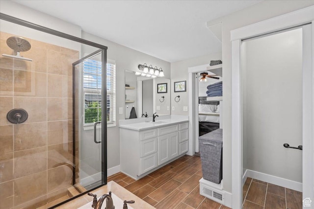 826 W 2630 N, Lehi, UT 84043 - ensuite bathroom featuring a stall shower, vanity, baseboards, and wood finish floors