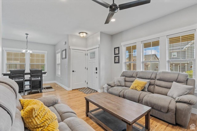 826 W 2630 N, Lehi, UT 84043 - living area featuring a chandelier, light wood finished floors, a ceiling fan, and baseboards
