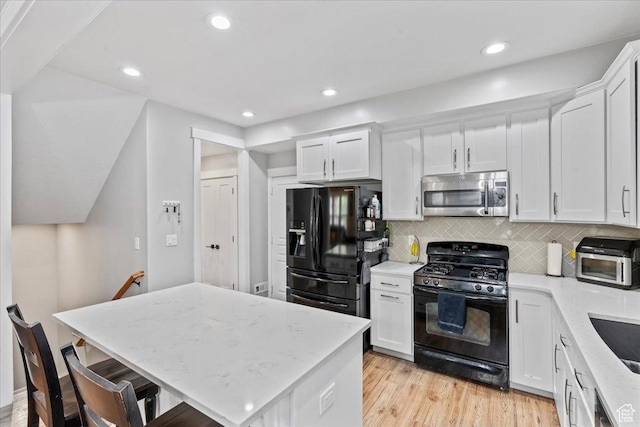 826 W 2630 N, Lehi, UT 84043 - kitchen with black appliances, white cabinetry, tasteful backsplash, light wood-style flooring, and recessed lighting