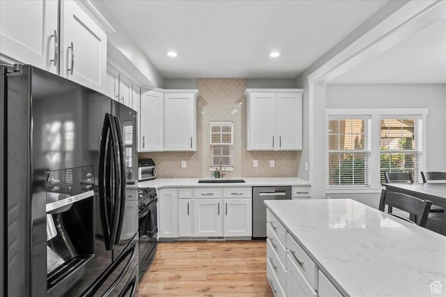 826 W 2630 N, Lehi, UT 84043 - kitchen with black appliances, white cabinetry, a sink, light wood-type flooring, and recessed lighting