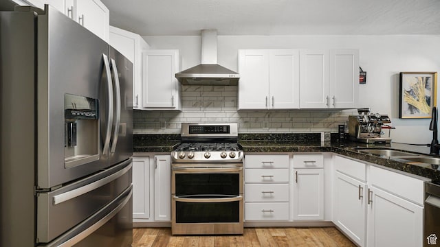 4475 S Lochnivar Ct E, Millcreek, UT 84107 - kitchen featuring stainless steel appliances, wall chimney range hood, a sink, and white cabinetry