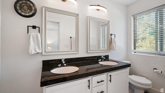 4475 S Lochnivar Ct E, Millcreek, UT 84107 - bathroom with healthy amount of natural light, double vanity, and toilet