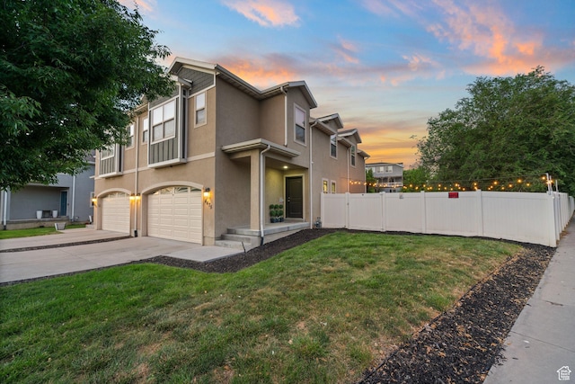 4475 S Lochnivar Ct E, Millcreek, UT 84107 - view of property exterior featuring a garage, driveway, and stucco siding