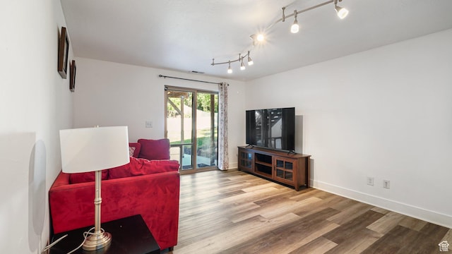 4475 S Lochnivar Ct E, Millcreek, UT 84107 - living area featuring wood finished floors, baseboards, and track lighting
