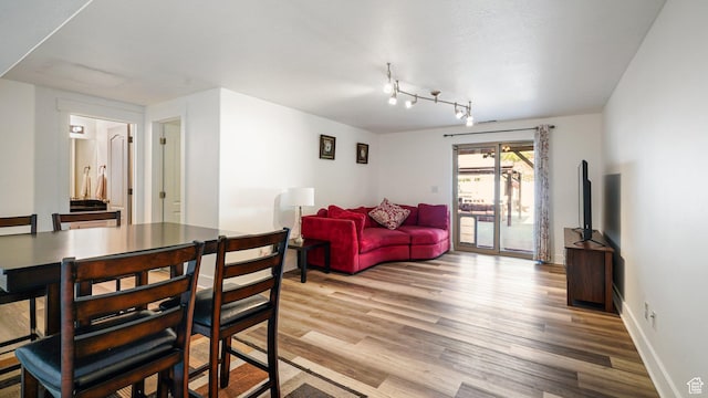 4475 S Lochnivar Ct E, Millcreek, UT 84107 - dining room with light wood-style floors, track lighting, and baseboards