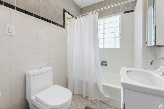 525 E St, Salt Lake City, UT 84103 - full bathroom featuring tile walls, shower / tub combo with curtain, toilet, vanity, and tile patterned flooring