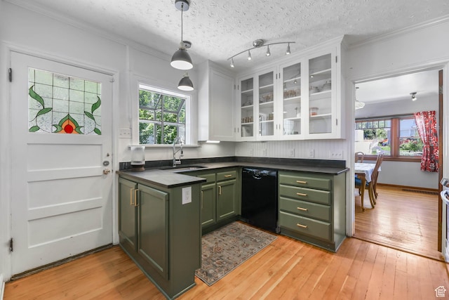 525 E St, Salt Lake City, UT 84103 - kitchen with green cabinetry, black dishwasher, a sink, dark countertops, and crown molding