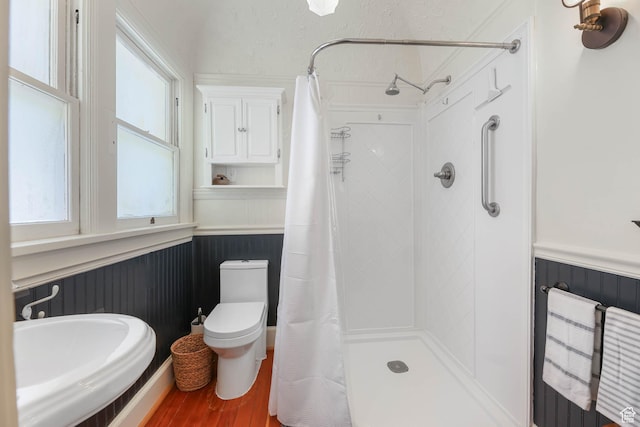 525 E St, Salt Lake City, UT 84103 - bathroom with a wainscoted wall, toilet, a shower with curtain, plenty of natural light, and wood finished floors
