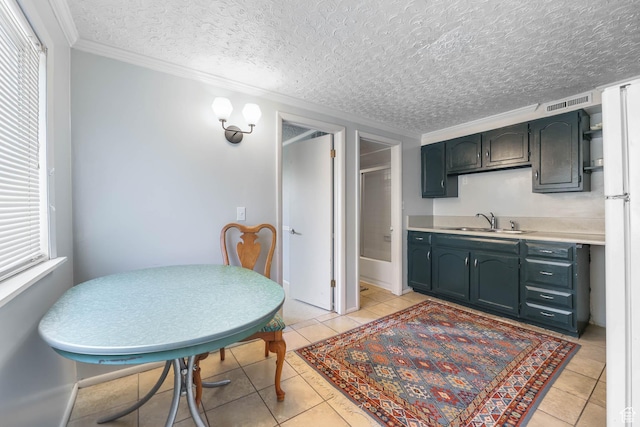 525 E St, Salt Lake City, UT 84103 - kitchen featuring a sink, light countertops, ornamental molding, light tile patterned flooring, and a textured ceiling