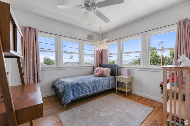 525 E St, Salt Lake City, UT 84103 - bedroom with crown molding, light wood-style flooring, baseboards, ceiling fan, and a textured ceiling