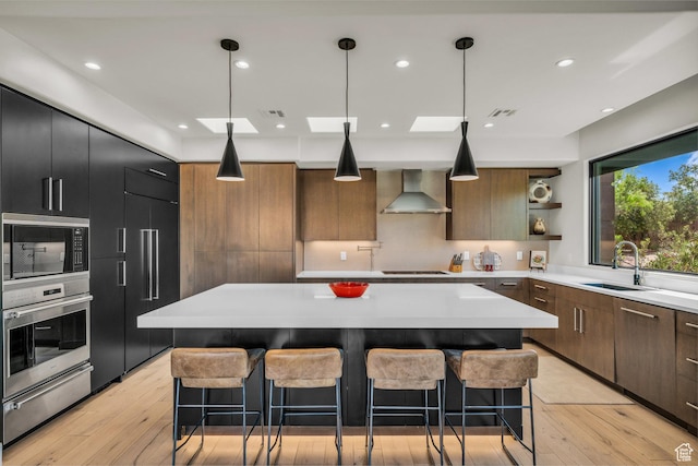 2304 N Cohonina Trl, St George, UT 84770 - kitchen featuring oven, wall chimney exhaust hood, black microwave, a warming drawer, and a sink