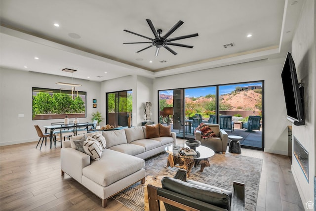 2304 N Cohonina Trl, St George, UT 84770 - living area with a raised ceiling, ceiling fan, light wood finished floors, baseboards, and recessed lighting