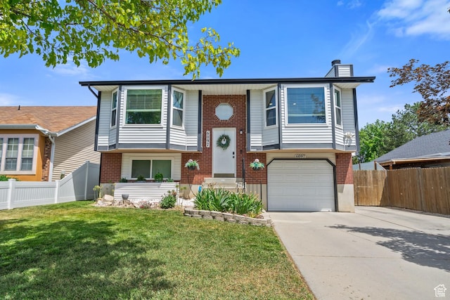 6097 S Azure Meadow Dr, Taylorsville, UT 84129 - bi-level home with driveway, brick siding, a chimney, and an attached garage