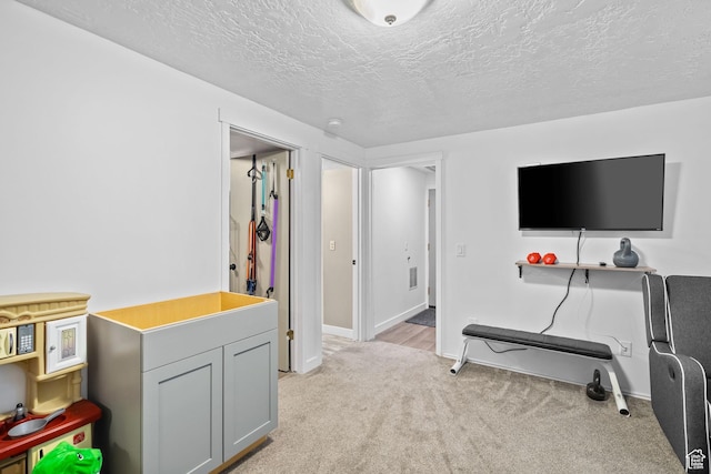 6097 S Azure Meadow Dr, Taylorsville, UT 84129 - rec room with light colored carpet, a textured ceiling, and baseboards