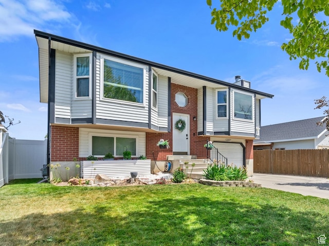 6097 S Azure Meadow Dr, Taylorsville, UT 84129 - split foyer home featuring brick siding, driveway, a garage, and a chimney