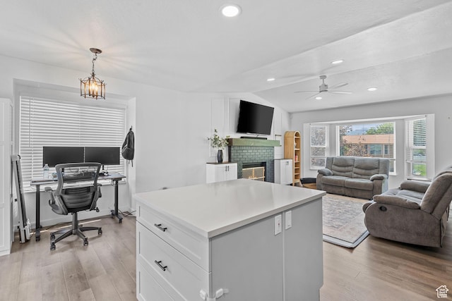 6097 S Azure Meadow Dr, Taylorsville, UT 84129 - home office with light wood-style flooring, ceiling fan, a fireplace, recessed lighting, and vaulted ceiling