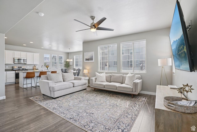 1123 W Osprey Dr, Stansbury Park, UT 84074 - living room with dark wood-type flooring, a ceiling fan, recessed lighting, and baseboards