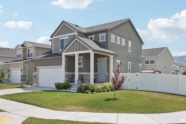 1123 W Osprey Dr, Stansbury Park, UT 84074 - craftsman-style house with board and batten siding, a garage, driveway, covered porch, and stone siding