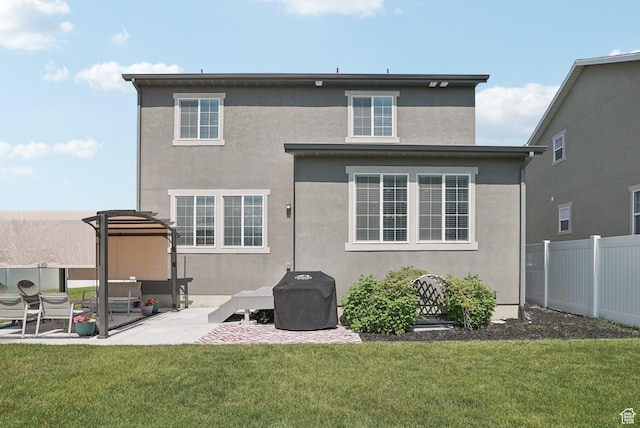 1123 W Osprey Dr, Stansbury Park, UT 84074 - back of property with a patio area and stucco siding