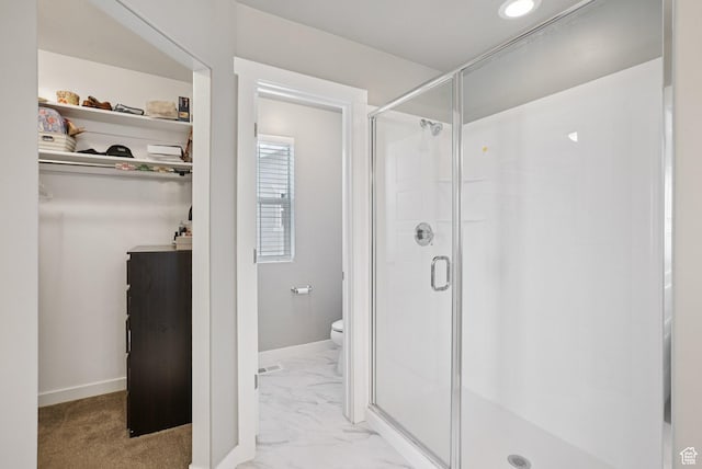 1123 W Osprey Dr, Stansbury Park, UT 84074 - bathroom featuring a stall shower, toilet, marble finish floors, baseboards, and a walk in closet