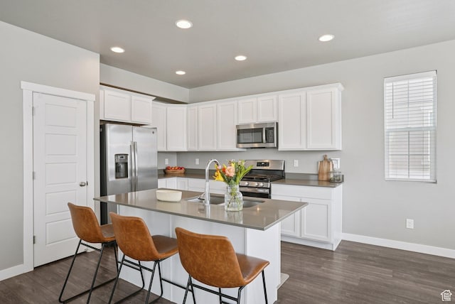 1123 W Osprey Dr, Stansbury Park, UT 84074 - kitchen featuring appliances with stainless steel finishes, a sink, baseboards, dark wood finished floors, and recessed lighting