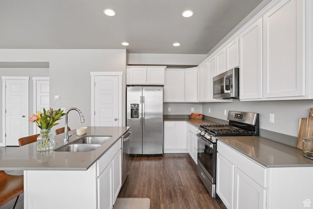 1123 W Osprey Dr, Stansbury Park, UT 84074 - kitchen featuring appliances with stainless steel finishes, a sink, white cabinets, dark wood-style floors, and recessed lighting