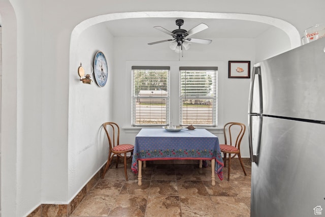 195 S 200 E, Monroe, UT 84754 - dining space with arched walkways, baseboards, ceiling fan, and stone finish flooring